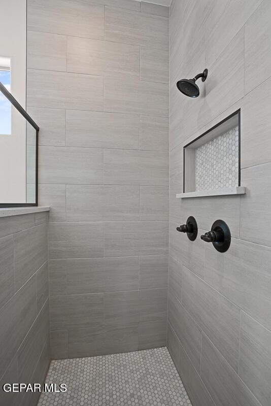 bathroom with tiled shower