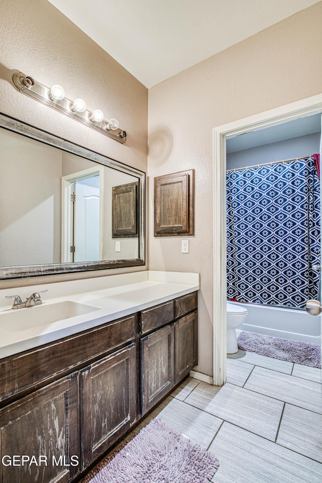 full bathroom featuring vanity, shower / tub combo, and toilet