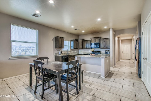 dining room featuring a wealth of natural light and sink