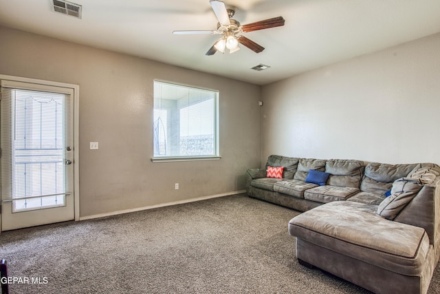 living room featuring carpet flooring and ceiling fan