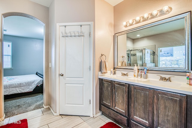 bathroom with vanity and a shower with shower door