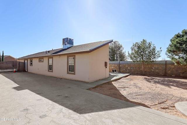 rear view of house with a patio and central AC unit