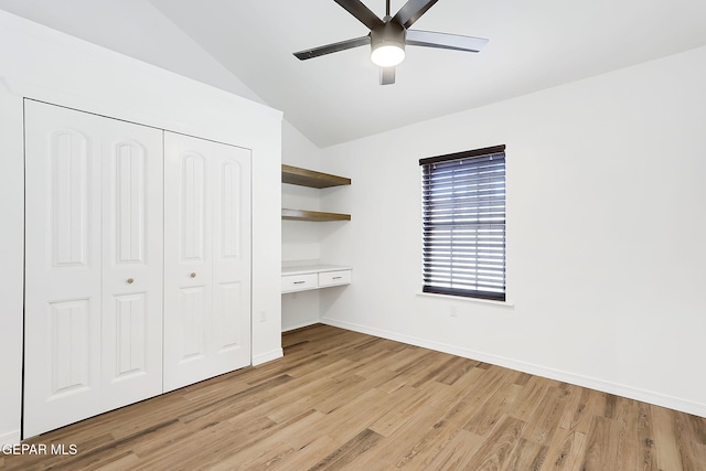 unfurnished bedroom featuring a closet, ceiling fan, light hardwood / wood-style flooring, and vaulted ceiling