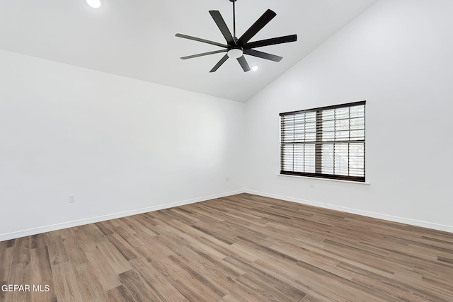 empty room with ceiling fan, high vaulted ceiling, and light hardwood / wood-style flooring