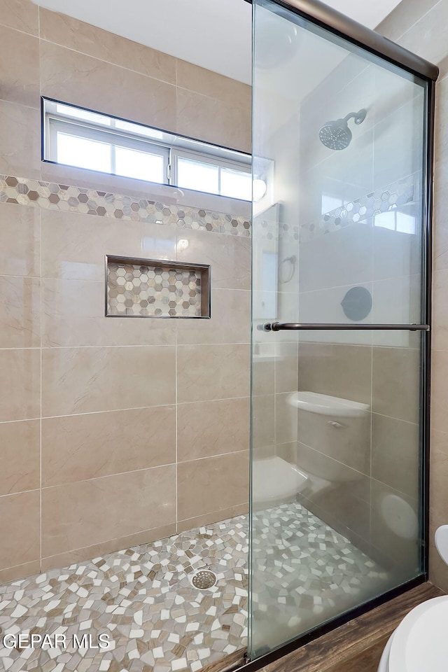 bathroom featuring an enclosed shower