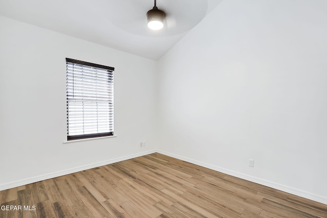 empty room featuring light hardwood / wood-style floors and lofted ceiling