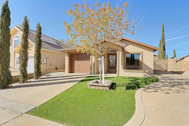 view of front of home with a garage and a front lawn