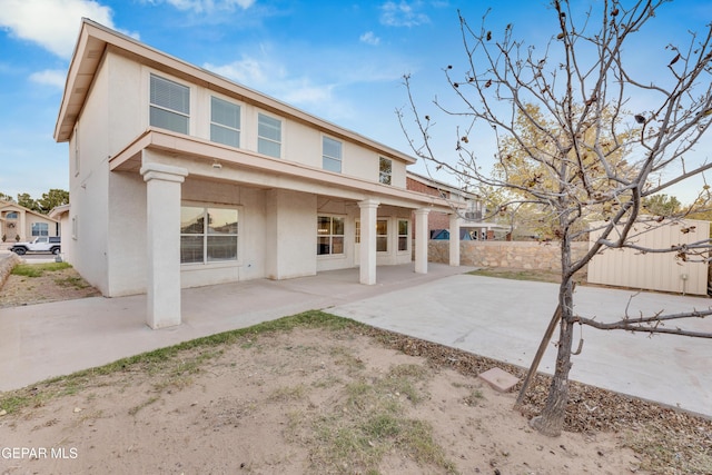 back of property with a patio