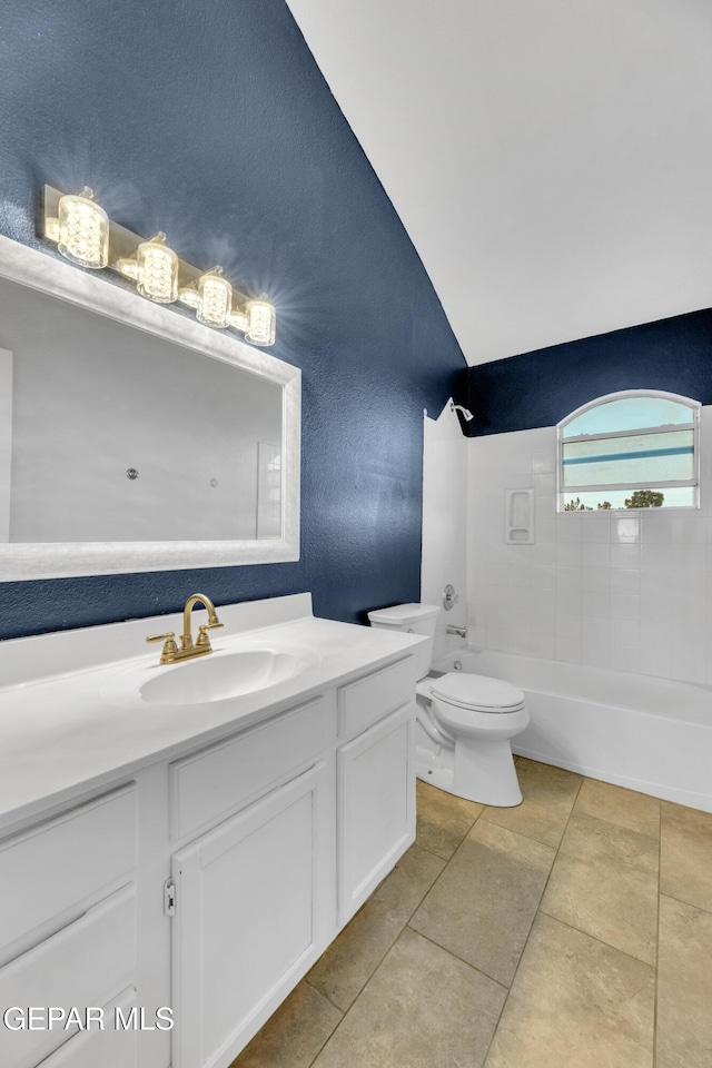 full bathroom featuring tile patterned floors, vanity, toilet, and tiled shower / bath