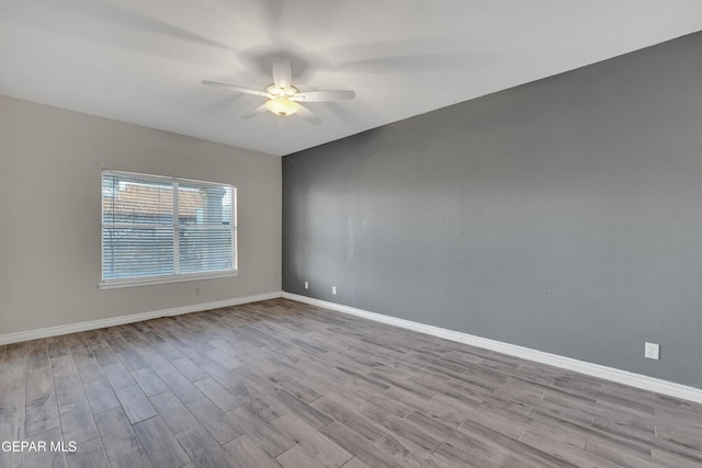 empty room with ceiling fan and light wood-type flooring