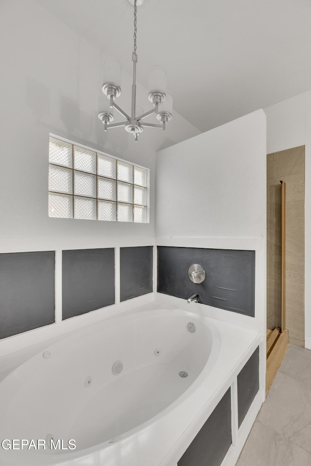 bathroom featuring a chandelier and independent shower and bath