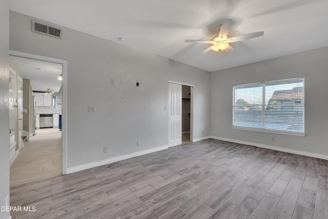 spare room with ceiling fan and light hardwood / wood-style floors