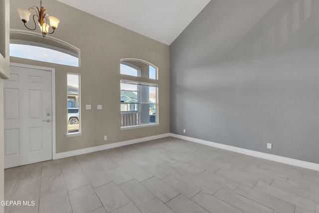 foyer featuring high vaulted ceiling and an inviting chandelier