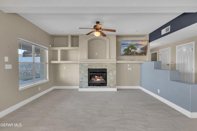 unfurnished living room with ceiling fan, a fireplace, and a textured ceiling