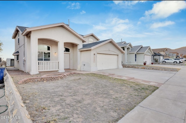 single story home with a porch and a garage