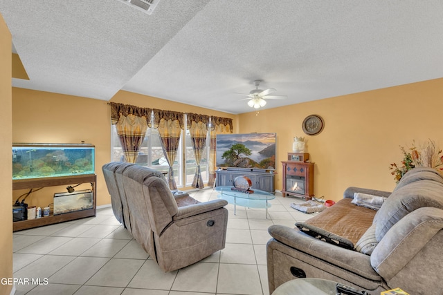 tiled living room with a textured ceiling and ceiling fan