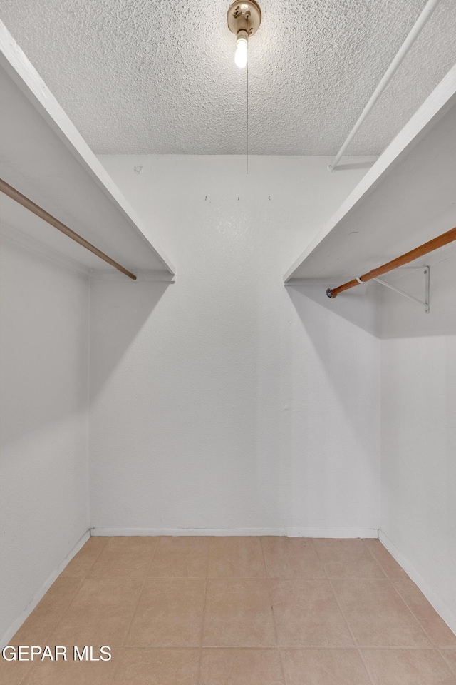 spacious closet featuring light tile patterned floors