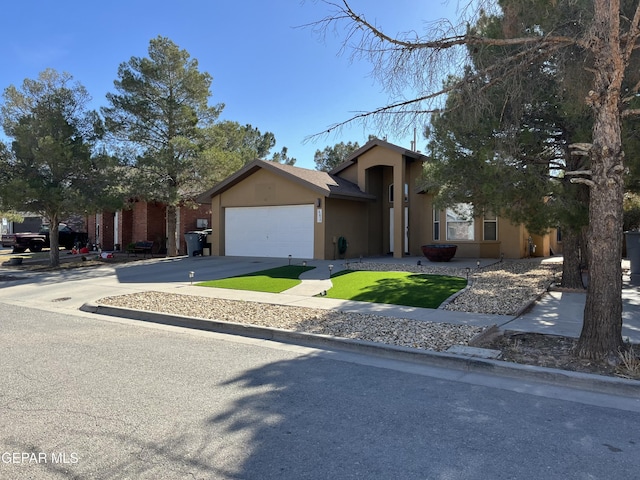 view of front facade with a garage and a front lawn