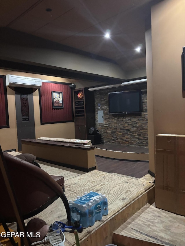 living room with a wall mounted air conditioner and wood-type flooring