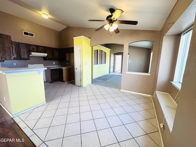 kitchen with dark brown cabinets, ceiling fan, lofted ceiling, and light tile patterned floors