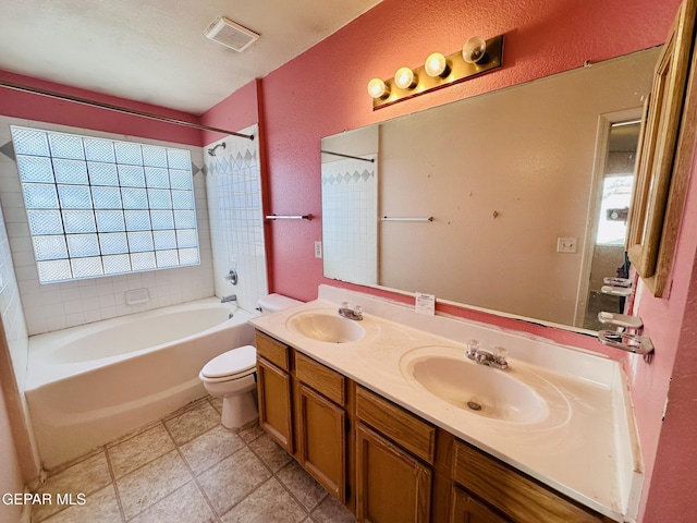 full bathroom with tile patterned flooring, vanity, toilet, and tiled shower / bath