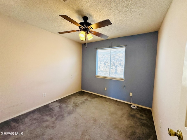 empty room featuring dark colored carpet, a textured ceiling, and ceiling fan