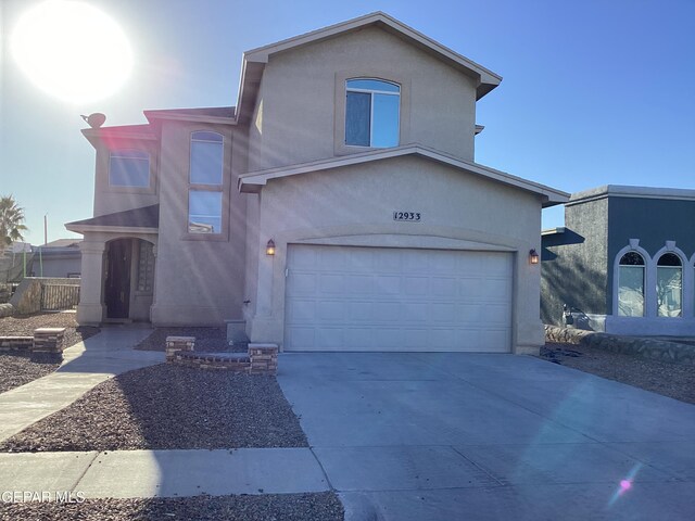12933 Hidden Grove Dr, El Paso, TX 79938 - view of front facade with an attached garage, stucco siding, and driveway