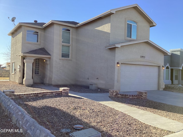 12933 Hidden Grove Dr, El Paso, TX 79938 - traditional-style home featuring an attached garage, stucco siding, and concrete driveway