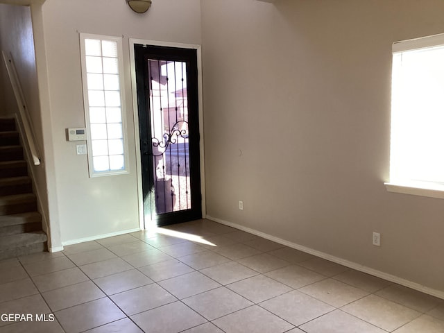 entryway with plenty of natural light and light tile patterned floors