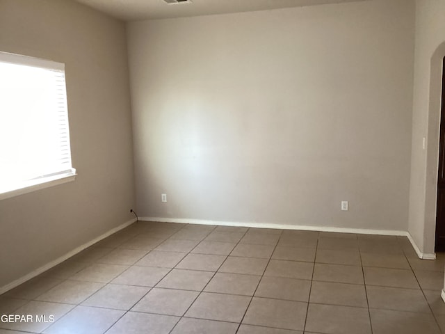 12933 Hidden Grove Dr, El Paso, TX 79938 - empty room featuring light tile patterned flooring and arched walkways