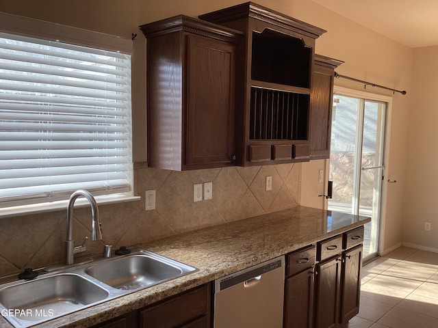 kitchen with sink, stainless steel dishwasher, decorative backsplash, dark brown cabinets, and light tile patterned floors