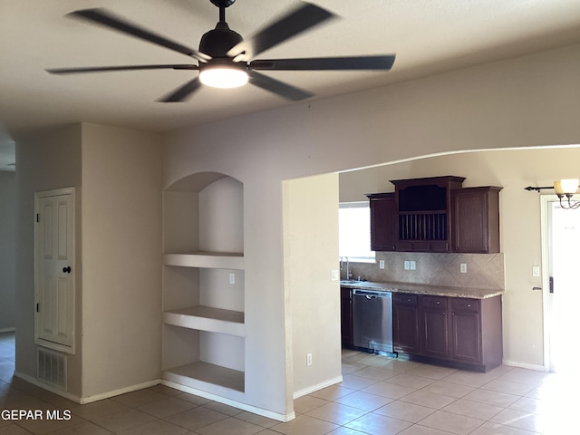 kitchen with backsplash, stainless steel dishwasher, dark brown cabinetry, ceiling fan, and light tile patterned floors