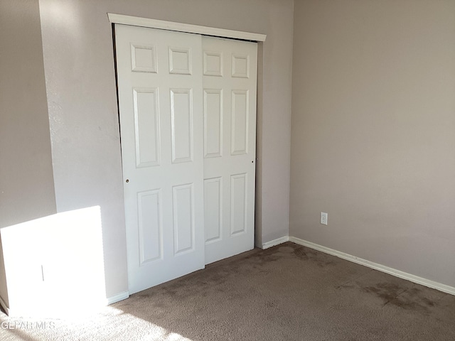 unfurnished bedroom with carpet floors and a closet