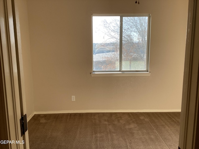 carpeted empty room featuring plenty of natural light