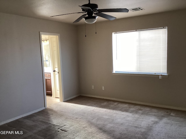 carpeted empty room featuring ceiling fan