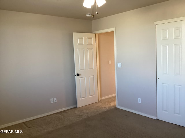 unfurnished bedroom featuring dark colored carpet