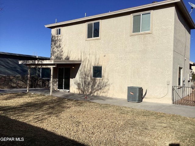 back of property with a patio area and cooling unit