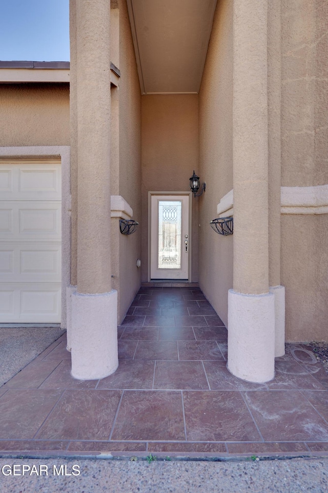 doorway to property with a garage