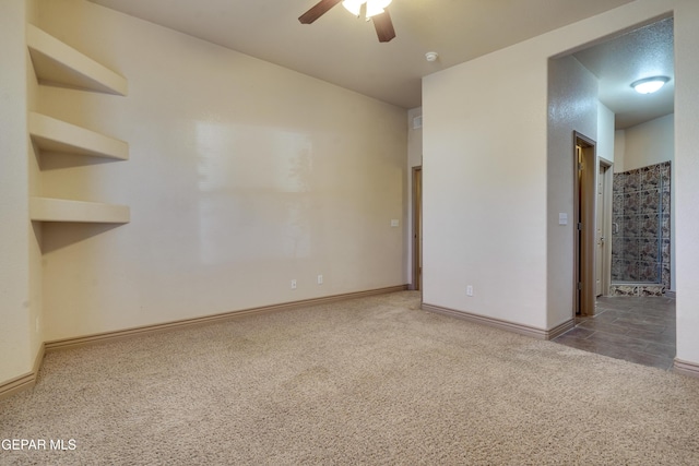 carpeted empty room featuring ceiling fan