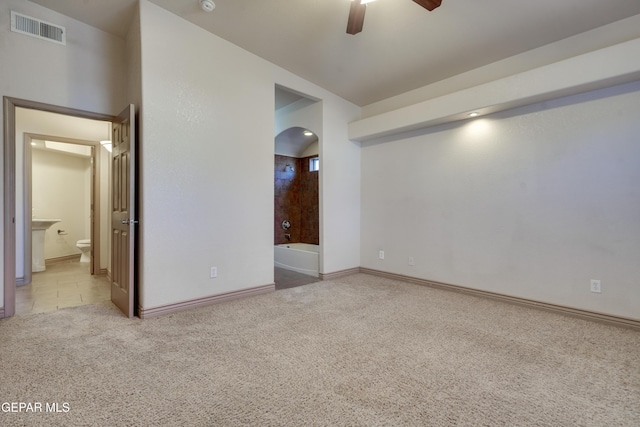 carpeted spare room featuring ceiling fan