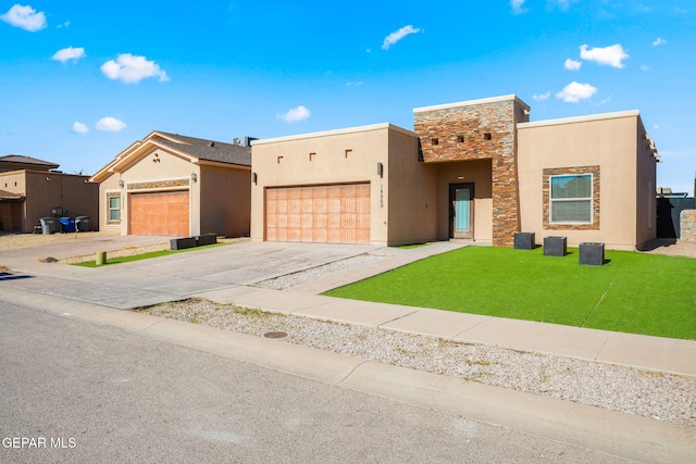 southwest-style home featuring a garage and a front lawn