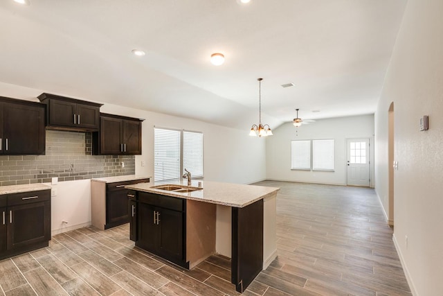 13820 Madero Ave, El Paso, TX 79928 - kitchen featuring a sink, backsplash, light wood-type flooring, dark brown cabinetry, and ceiling fan