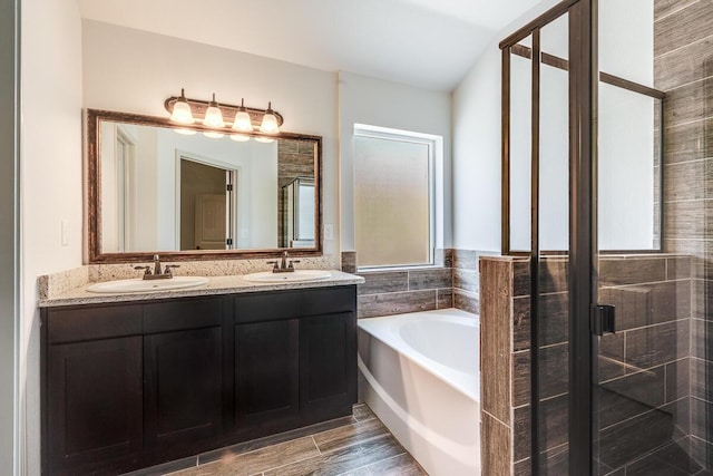 13820 Madero Ave, El Paso, TX 79928 - bathroom with a bath, a shower stall, double vanity, and wood finished floors