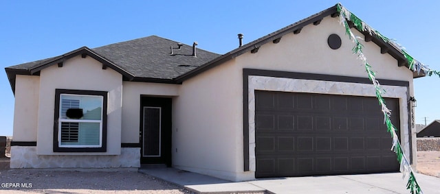 13820 Madero Ave, El Paso, TX 79928 - view of front facade with a garage, a shingled roof, stucco siding, and concrete driveway
