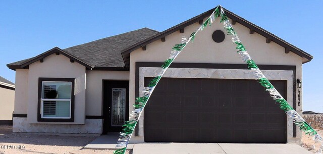 13820 Madero Ave, El Paso, TX 79928 - view of front of property with a garage, a shingled roof, and stucco siding