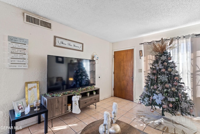 living room with light tile patterned floors and a textured ceiling