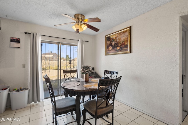 tiled dining space featuring ceiling fan and a textured ceiling