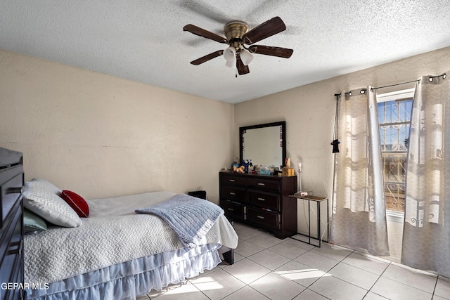 tiled bedroom featuring ceiling fan and a textured ceiling