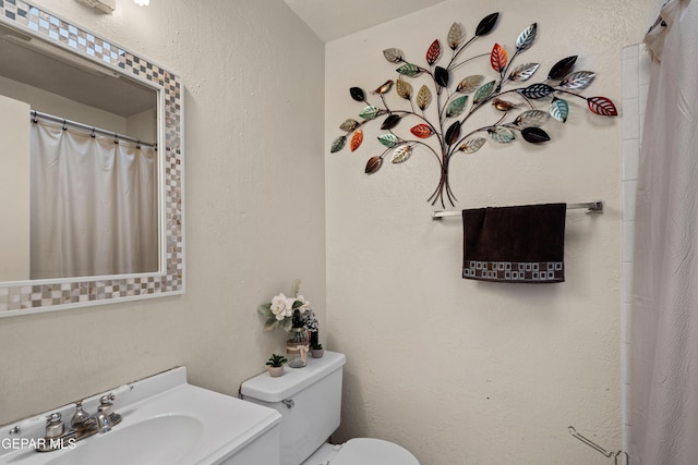 bathroom featuring toilet and sink