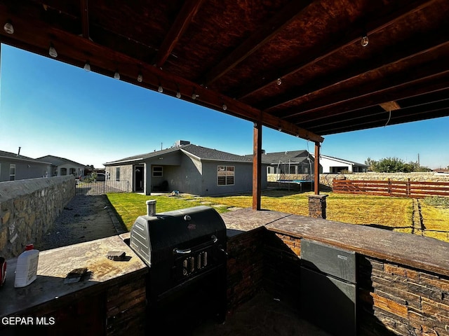 view of patio / terrace featuring an outdoor kitchen and a grill